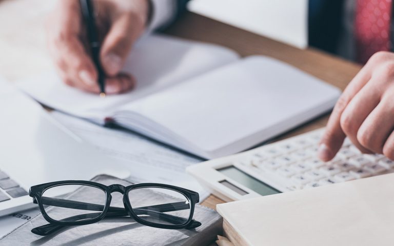 man working on a finance calculator